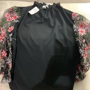 Ruffled neck black blouse with decorative sheer long sleeves